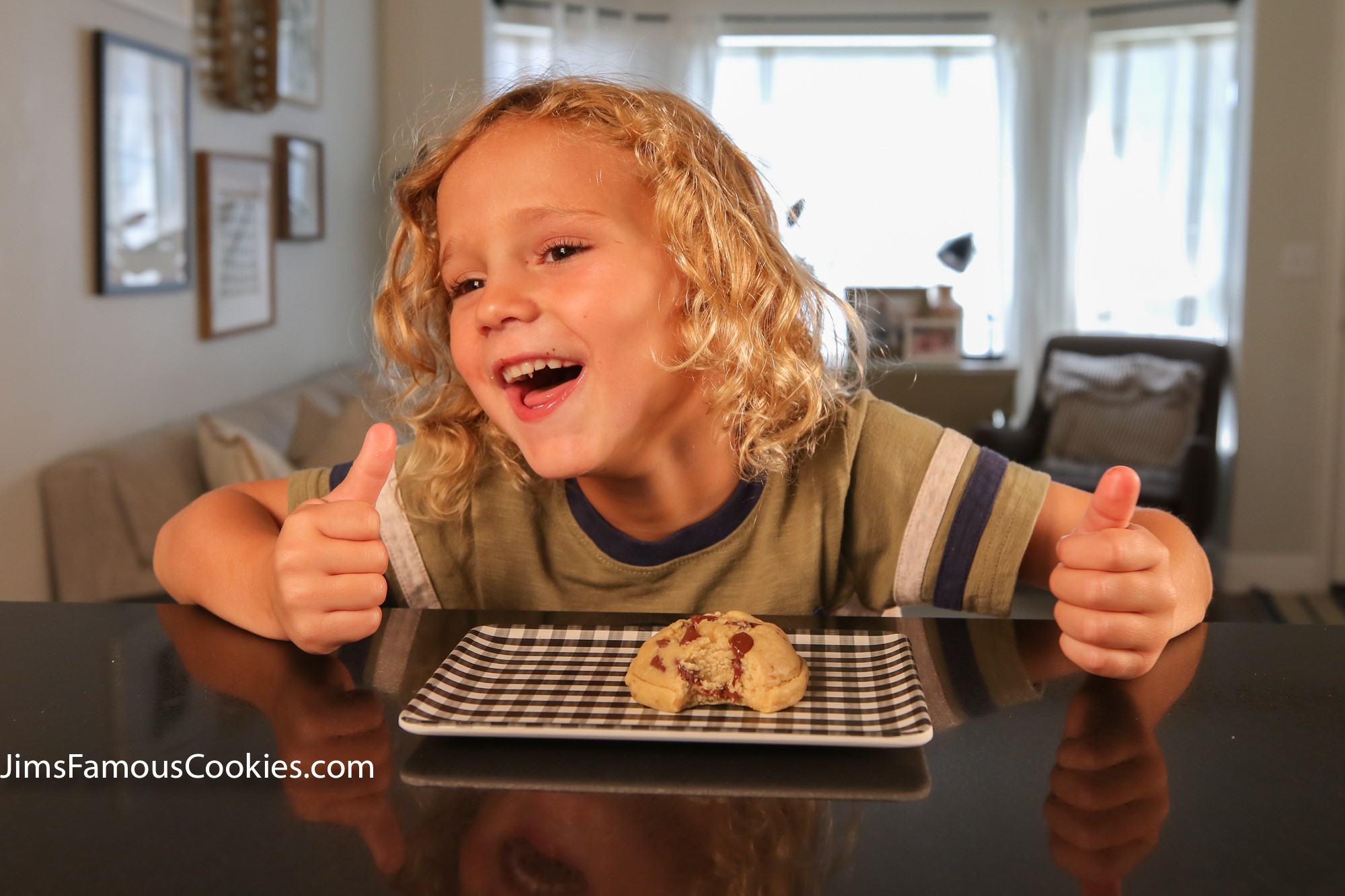 A happy customer giving two thumbs up for Jim's Famous Cookies